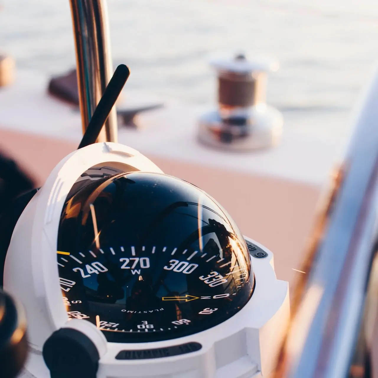 white and black compass pointing at 0 shallow focus photography